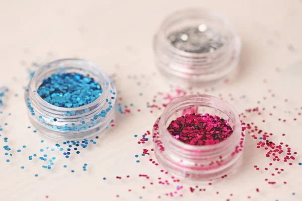 Multi-colored Sequins for the design of nails in a box. Glitter in jars. Foil for nail service. Photo set. Sparkling beauty shimmer, glitter.