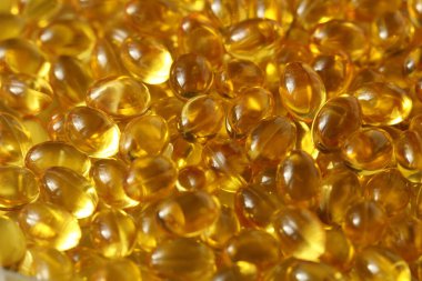 Altın arka plan kapsülleri gıda takviyesi kapsüllerini kapatın A vitamini, D3 vitamini, balık yağı, Omega 3, 6, 9, akşam çuha çiçeği yağı, keten tohumu yağı, D vitamini, E vitamini.