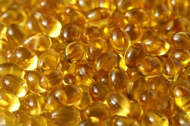 Altın arka plan kapsülleri gıda takviyesi kapsüllerini kapatın A vitamini, D3 vitamini, balık yağı, Omega 3, 6, 9, akşam çuha çiçeği yağı, keten tohumu yağı, D vitamini, E vitamini.