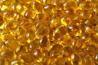 Altın arka plan kapsülleri gıda takviyesi kapsüllerini kapatın A vitamini, D3 vitamini, balık yağı, Omega 3, 6, 9, akşam çuha çiçeği yağı, keten tohumu yağı, D vitamini, E vitamini.