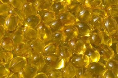 Altın arka plan kapsülleri gıda takviyesi kapsüllerini kapatın A vitamini, D3 vitamini, balık yağı, Omega 3, 6, 9, akşam çuha çiçeği yağı, keten tohumu yağı, D vitamini, E vitamini.