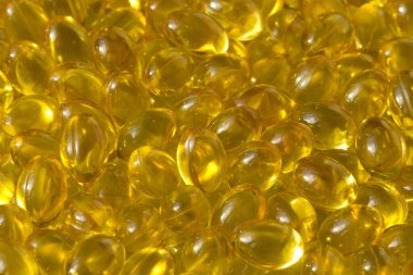 Altın arka plan kapsülleri gıda takviyesi kapsüllerini kapatın A vitamini, D3 vitamini, balık yağı, Omega 3, 6, 9, akşam çuha çiçeği yağı, keten tohumu yağı, D vitamini, E vitamini.