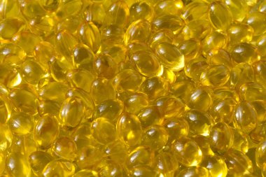 Altın arka plan kapsülleri gıda takviyesi kapsüllerini kapatın A vitamini, D3 vitamini, balık yağı, Omega 3, 6, 9, akşam çuha çiçeği yağı, keten tohumu yağı, D vitamini, E vitamini.