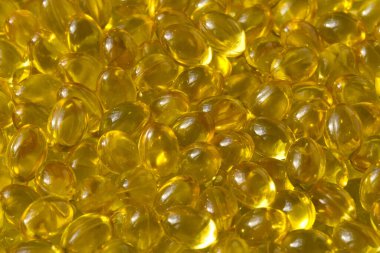 Altın arka plan kapsülleri gıda takviyesi kapsüllerini kapatın A vitamini, D3 vitamini, balık yağı, Omega 3, 6, 9, akşam çuha çiçeği yağı, keten tohumu yağı, D vitamini, E vitamini.