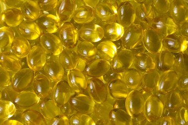Altın arka plan kapsülleri gıda takviyesi kapsüllerini kapatın A vitamini, D3 vitamini, balık yağı, Omega 3, 6, 9, akşam çuha çiçeği yağı, keten tohumu yağı, D vitamini, E vitamini.