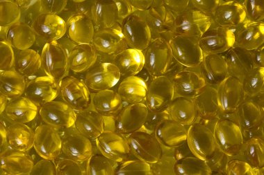 Altın arka plan kapsülleri gıda takviyesi kapsüllerini kapatın A vitamini, D3 vitamini, balık yağı, Omega 3, 6, 9, akşam çuha çiçeği yağı, keten tohumu yağı, D vitamini, E vitamini.