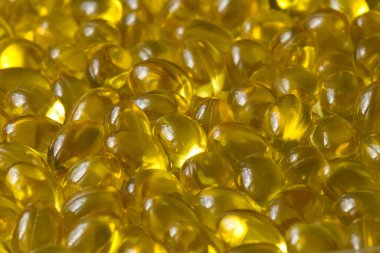 Altın arka plan kapsülleri gıda takviyesi kapsüllerini kapatın A vitamini, D3 vitamini, balık yağı, Omega 3, 6, 9, akşam çuha çiçeği yağı, keten tohumu yağı, D vitamini, E vitamini.