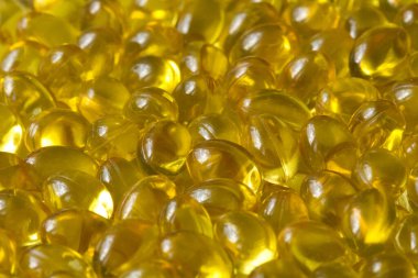 Altın arka plan kapsülleri gıda takviyesi kapsüllerini kapatın A vitamini, D3 vitamini, balık yağı, Omega 3, 6, 9, akşam çuha çiçeği yağı, keten tohumu yağı, D vitamini, E vitamini.