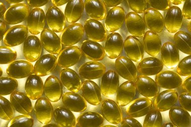 Altın arka plan kapsülleri gıda takviyesi kapsüllerini kapatın A vitamini, D3 vitamini, balık yağı, Omega 3, 6, 9, akşam çuha çiçeği yağı, keten tohumu yağı, D vitamini, E vitamini.