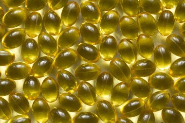 Altın arka plan kapsülleri gıda takviyesi kapsüllerini kapatın A vitamini, D3 vitamini, balık yağı, Omega 3, 6, 9, akşam çuha çiçeği yağı, keten tohumu yağı, D vitamini, E vitamini.