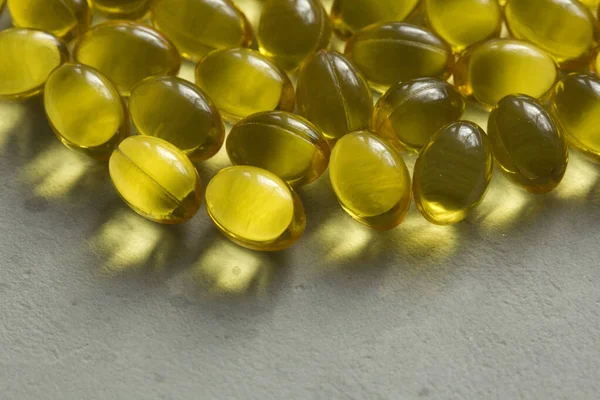 Close up food supplement oil filled capsules suitable vitamin A, vitamin D3, fish oil, omega 3, 6, 9, evening primrose, borage oil, flax seeds oil, vitamin D, vitamin E. Copy space for your text.