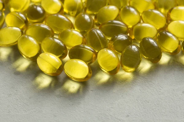 Close up food supplement oil filled capsules suitable vitamin A, vitamin D3, fish oil, omega 3, 6, 9, evening primrose, borage oil, flax seeds oil, vitamin D, vitamin E. Copy space for your text.