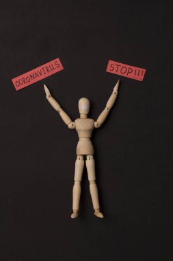 Tahta adam Coronavirus 'un durmasını istiyor. Salgın, panik, iyileşme, siyah arka planda kırmızı kelimeler. Enfeksiyonlar havadan damlacıklarla bulaşan kovid 19. Tahta küçük adamlar ve insanlar.