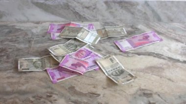 Üzerinde Mahatma Gandi resmi olan 10, 50, 100,500, 2000 rupilik kağıt Hindistan rupisi mermer arka planda yere düşüyor. Yakın plan..
