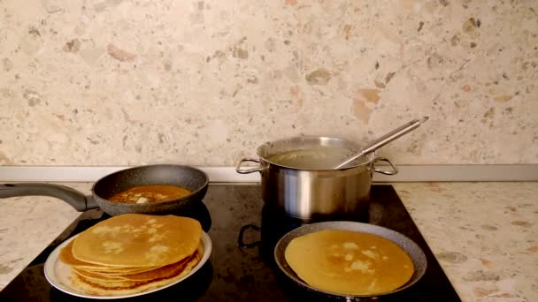 Female Hand Bakes Traditional Russian Tasty Pancakes Electric Modern Stove — Stock Video