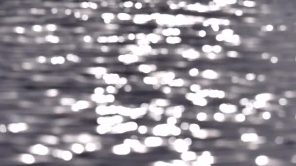 Ondulations et éblouissement du soleil sur l'eau des vagues. Ondulation de la mer. Éblouissement du soleil sur l'eau. Éblouissement flou sur l'eau. Fond d'eau trouble, détendez-vous. L'éblouissement du soleil sur les vagues. Mouvement lent 