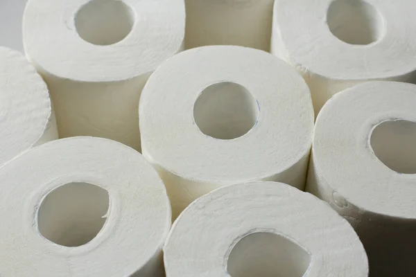 Toilet paper rolls closeup lies on a white background. Shortage of toilet paper due to coronavirus. Copy space for your text.