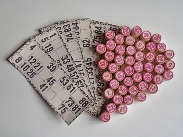 Russian lotto, bingo board game, barrels and cards on a white background. Quarantine Games Concept. Board game lotto with wooden barrels. Money game, luck, luck, excitement, board games, stay home.