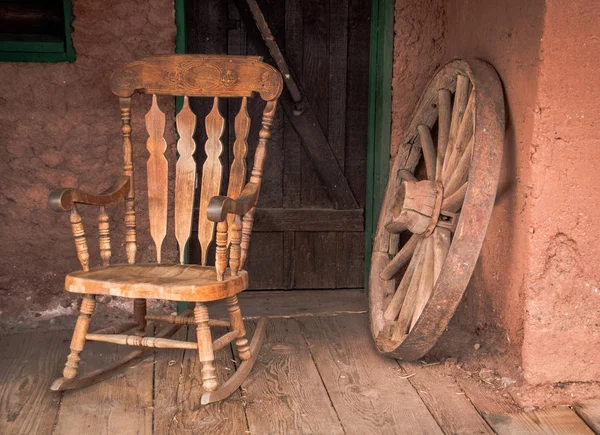 Rocking chair and old wooden wheel in Calico ghost town in USA
