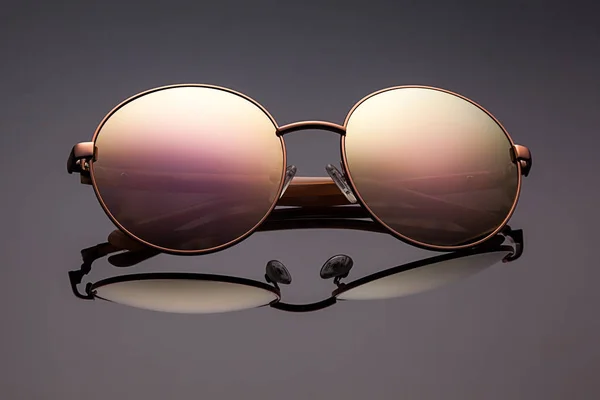 Stylish polarized mirrored sunglasses on grey background. — Stock Photo, Image