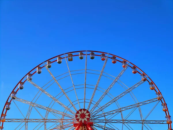 Part of observation wheel with blue sky background