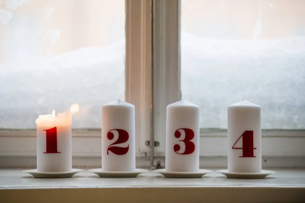 Numbered candles, one burning — Stock Photo, Image