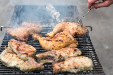 Izgara üzerinde Man Fry biftekler ve Tavuk uyluk, açık havada arkadaşlarınızla dinlenme
