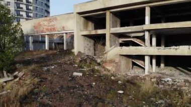 Terk edilmiş inşaatın dış görünüşü. Mülkün maliyetini düşürmek için yapay tahribat teması. Hava aracı 4k sinematik görüntüler