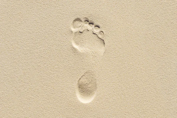 Footprint on the clean light sand. Man on earth.