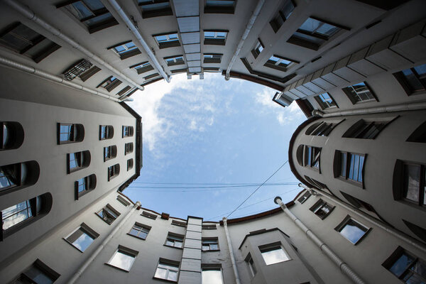 Yard-well of bottom-up with blue sky classical architecture of old Saint Petersburg, Russia