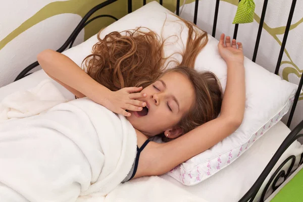 Menina acordando em sua cama — Fotografia de Stock