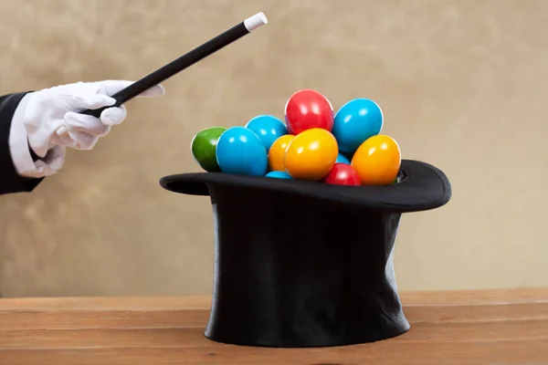 Magician hand with magic wand bringing the easter eggs in a hard