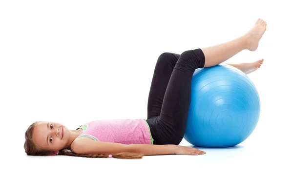 Happy young girl exercising with large gymnastic rubber ball — Stock Photo, Image