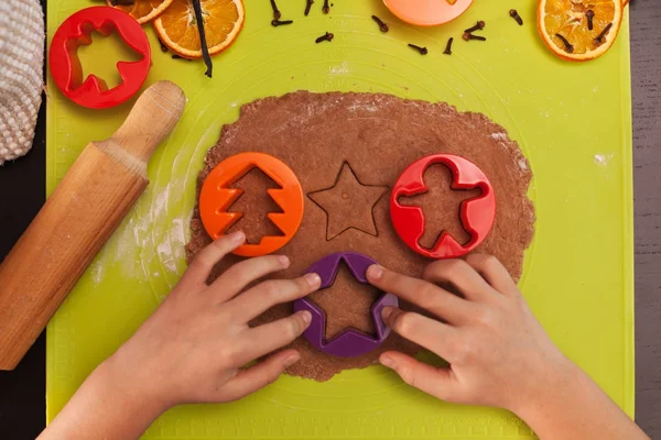 Child hands making gingerbread cookies - top view — Stock Photo, Image