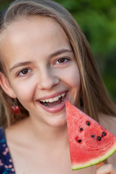 Happy young girl with a slice of watermelon on a stick — Stock Photo, Image