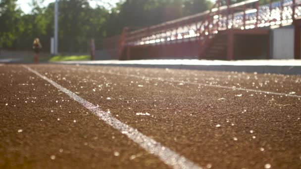 Running sport girl at stadium race in a sunny morning — Stock Video