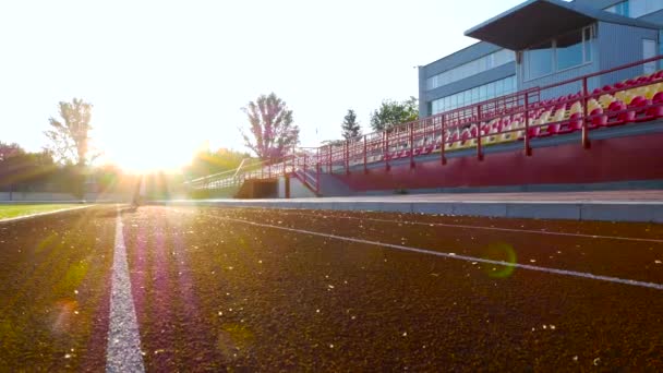 Running girl at sunrise stadium — Stock Video