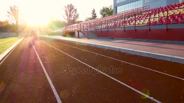Beautiful running girl at stadium race — Stock Video
