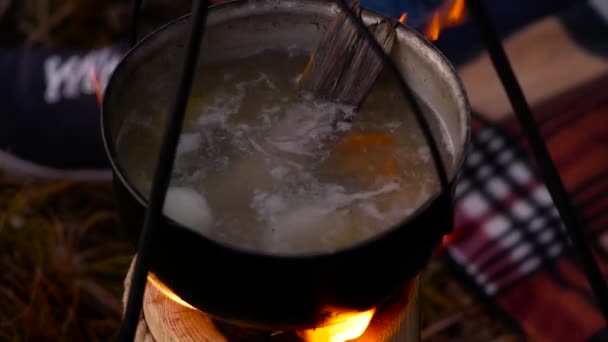 Boiling fish soup on the fire. Slow motion — Stock Video