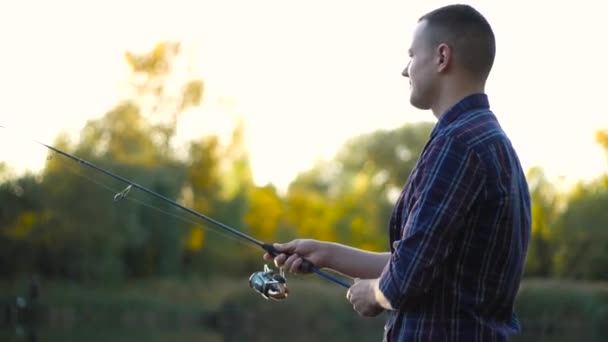Man fishing with spinning rod — Stock Video