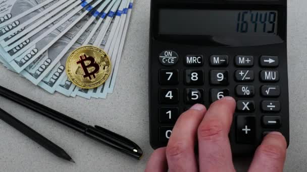 Gold bitcoin with USD and calculator on the table — Stock Video