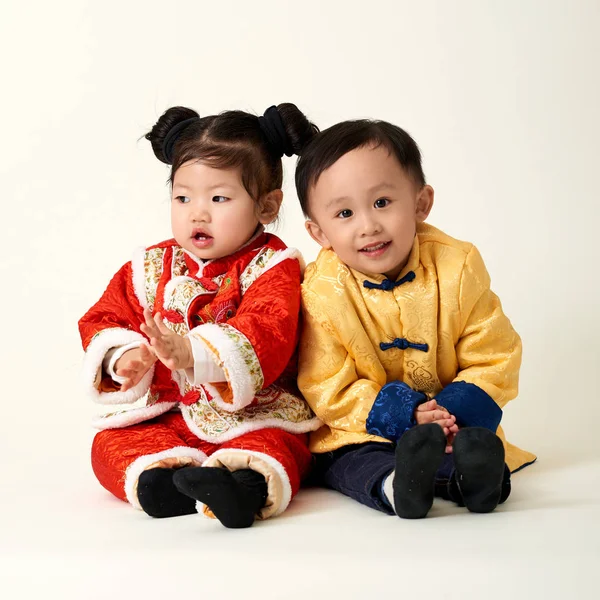Китайский мальчик и девочка в традиционном китайском новогоднем наряде — стоковое фото