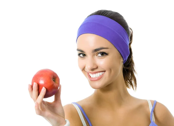 Frau in violetter Sportbekleidung mit rotem Apfel, isoliert — Stockfoto