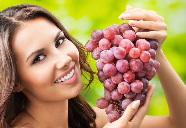 Young happy smiling woman with grapes, outdoors — Stock Photo, Image