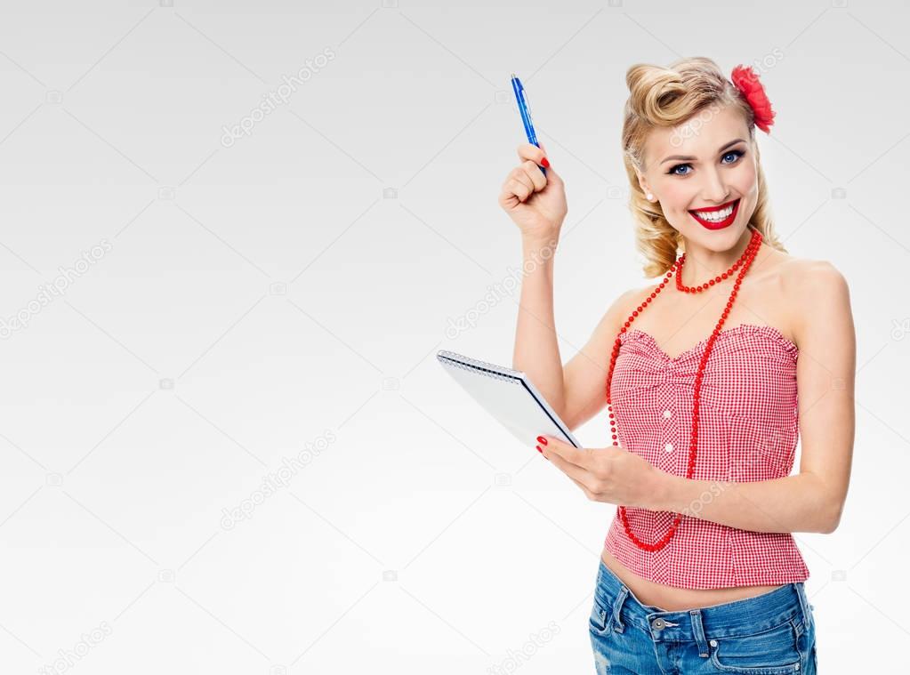 smiling woman with notepad, in pin-up style clothing