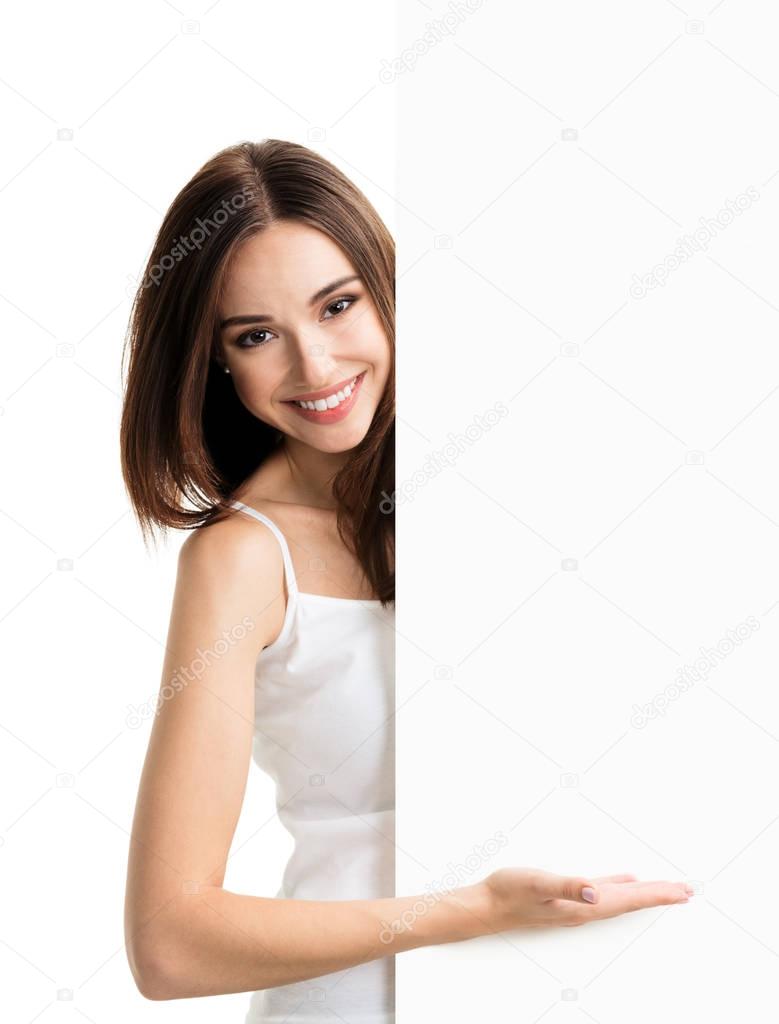 Brunette woman in casual clothing showing blank signboard