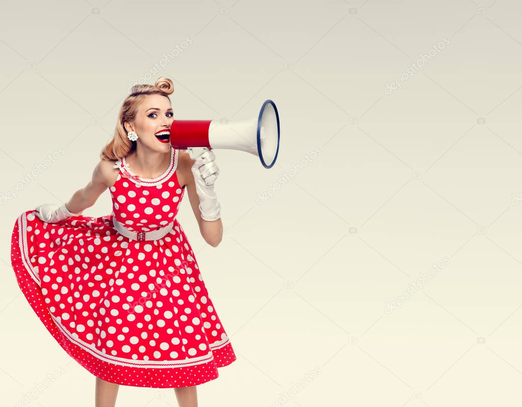 happy woman holding megaphone, dressed in pin-up style red dress