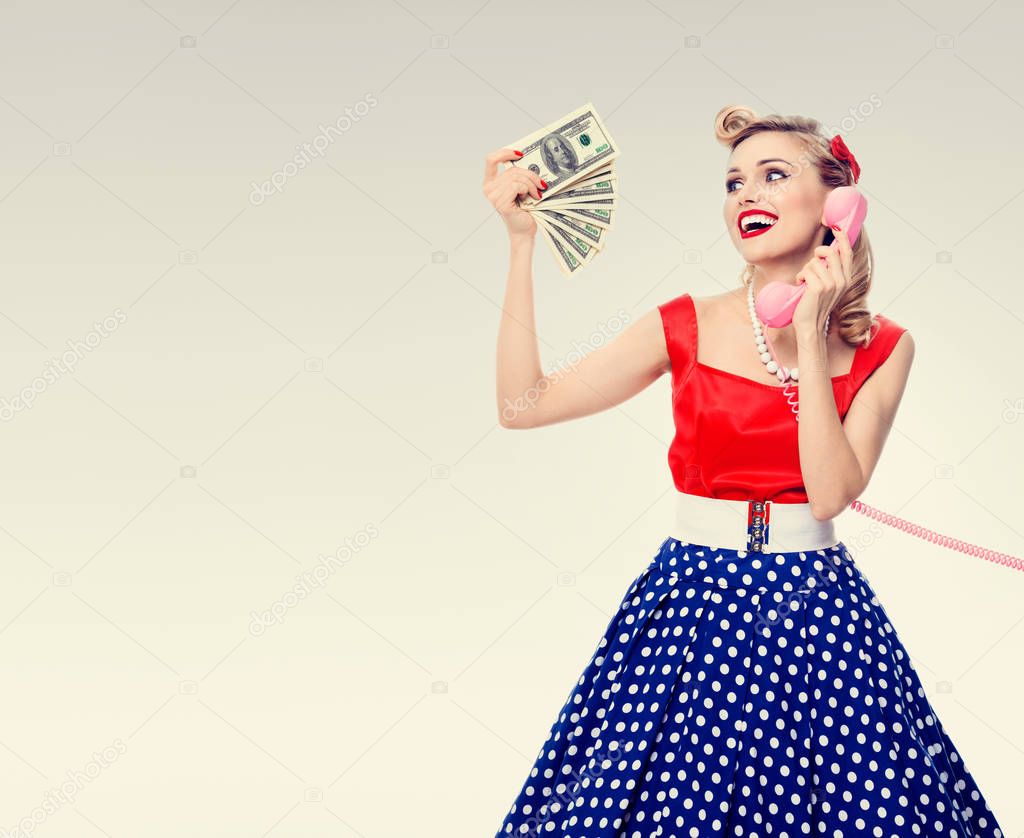 woman with money, talking on phone, dressed in pin-up style dres