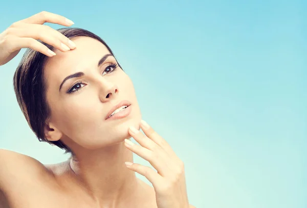 Woman touching skin or applying cream, blue — Stock Photo, Image