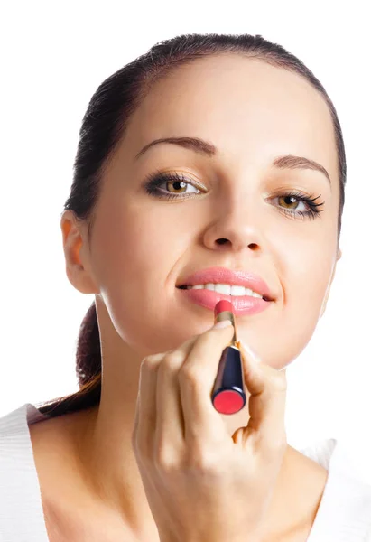 Portrait of young woman applying lipstick, isolated — Stock Photo, Image